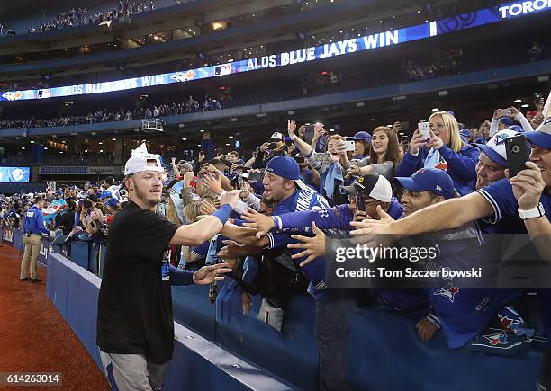 Josh Donaldson of the Toronto Blue Jays celebrates with fans after winning the game and series in the tenth inning during MLB game action against the...