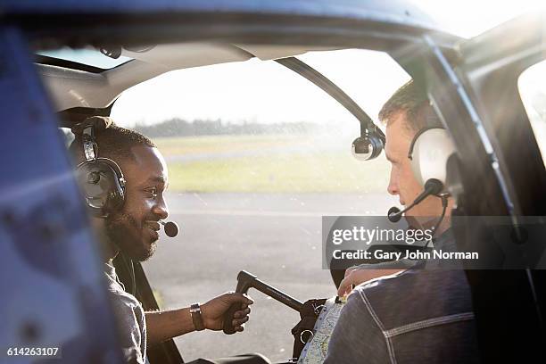 student in helicopter cockpit taking controls - helicopter cockpit stock pictures, royalty-free photos & images