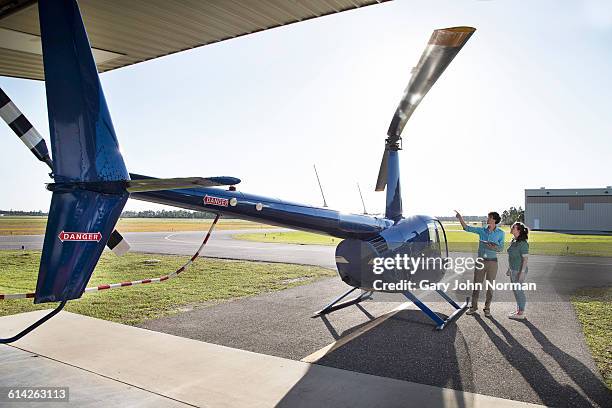 female student pilot listening to instructor - helicopter pilot stock pictures, royalty-free photos & images