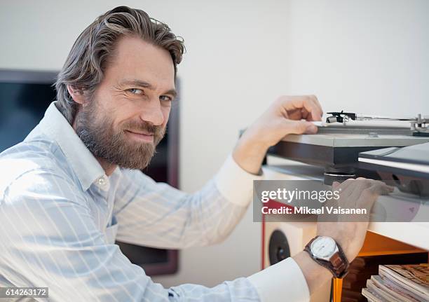 close up portrait of bearded man at home with hifi equipment - obsessive stock pictures, royalty-free photos & images
