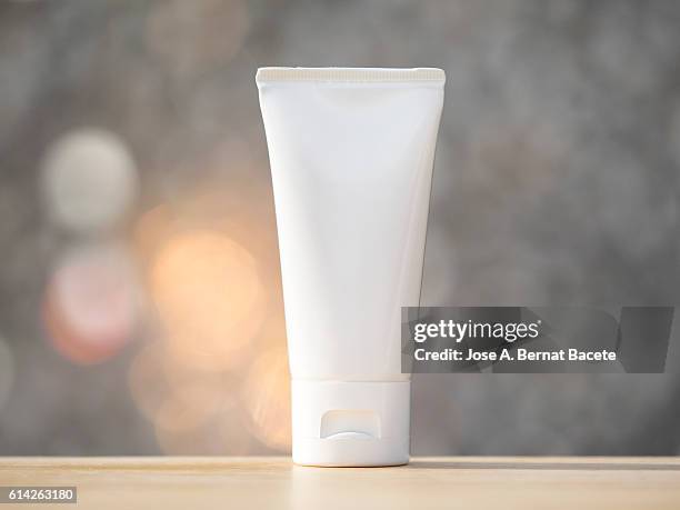cosmetic plastic tube blank, close up, illuminated by sunlight - creme tube ストックフォトと画像