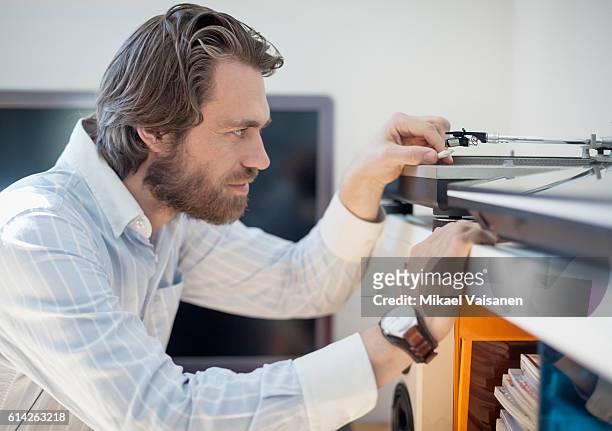 close up portrait of bearded man at home with hifi equipment - personal stereo stockfoto's en -beelden