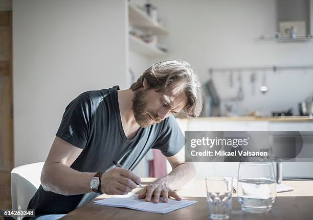 portrait of bearded man sitting at home - form ストックフォトと画像