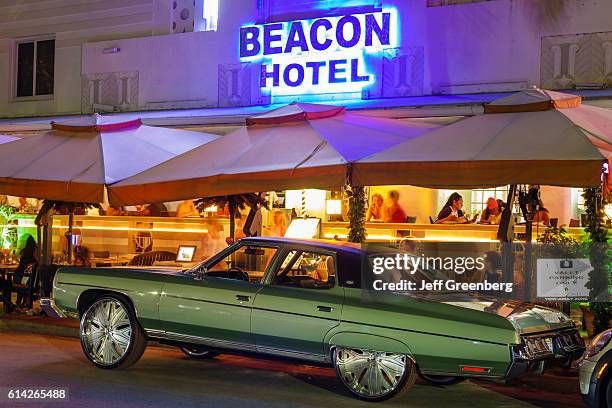 Pimped classic car outside Beacon hotel at night.