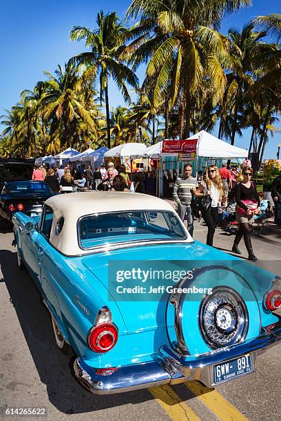 The rear of a 1956 Thunderbird T-bird at an antique classic car automobile show.