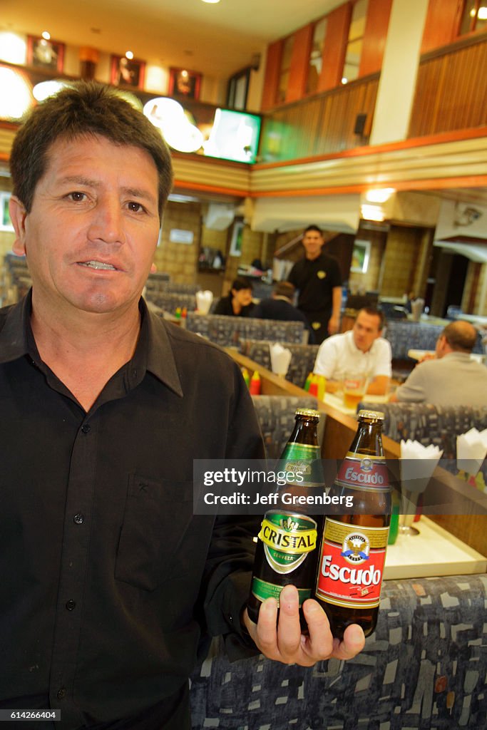 Parrilladas Prosit, restaurant, Chilean cuisine, waiter holding domestic beer bottles.