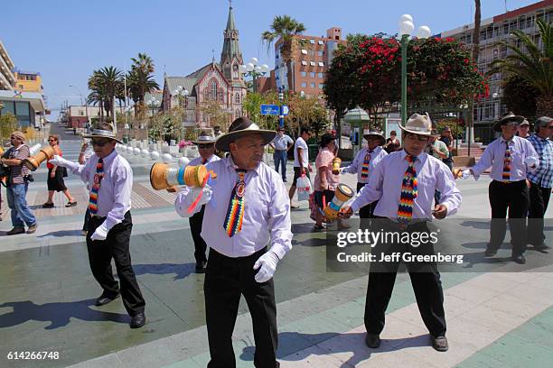 Men dancing at the Andean Carnival parade rehearsal, outside the San Marcos Cathedral.