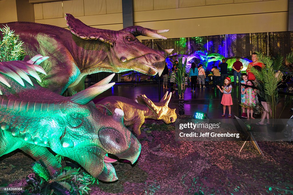 A family looking at Kosmoceratops in Discover the Dinosaurs, Convention Center.