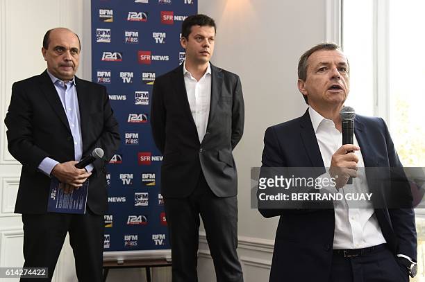 President of the NextRadioTV group and CEO of SFR group in charge of Media activities Alain Weill stands next to BFM TV's editorial director Herve...