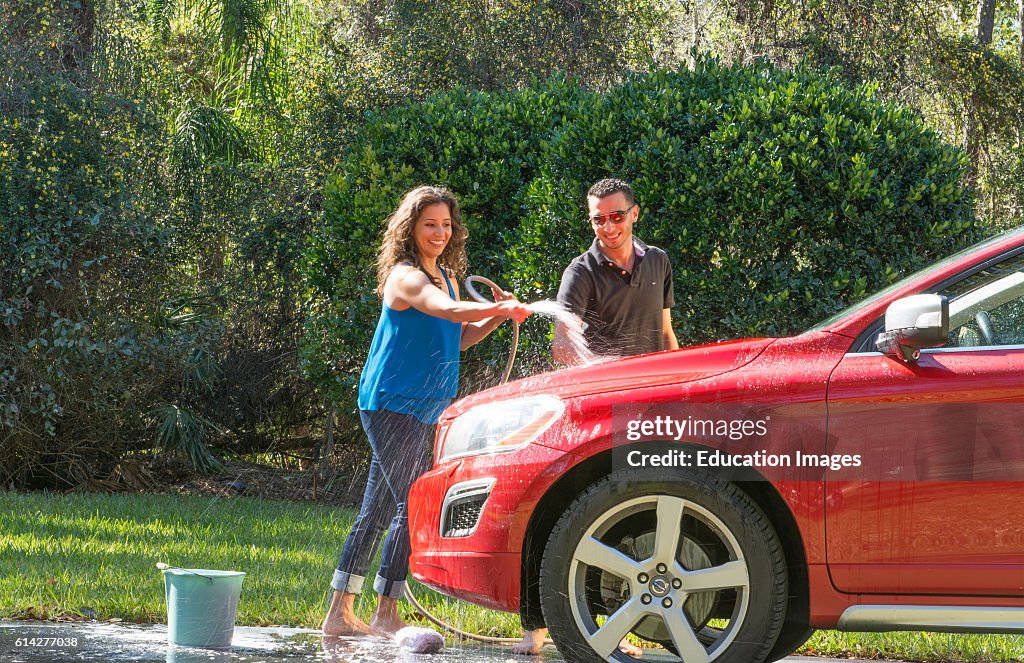 Couple wash car at home