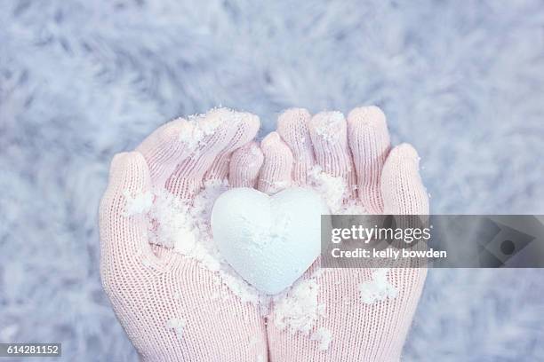 winter love heart shape snow in hands wearing gloves - glove imagens e fotografias de stock