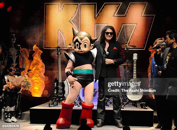 Gene Simmons of KISS poses for photographs with Astro Boy at the opening of the KISS EXPO Tokyo at Laforet Museum Harajuku on October 13, 2016 in...