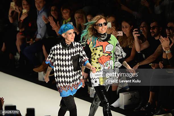 Designers, Deniz Berdan and Begum Berdan are applauded walks the runway at the DB Berdan show during Mercedes-Benz Fashion Week Istanbul at Zorlu...