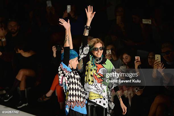 Designers, Deniz Berdan and Begum Berdan are applauded walks the runway at the DB Berdan show during Mercedes-Benz Fashion Week Istanbul at Zorlu...