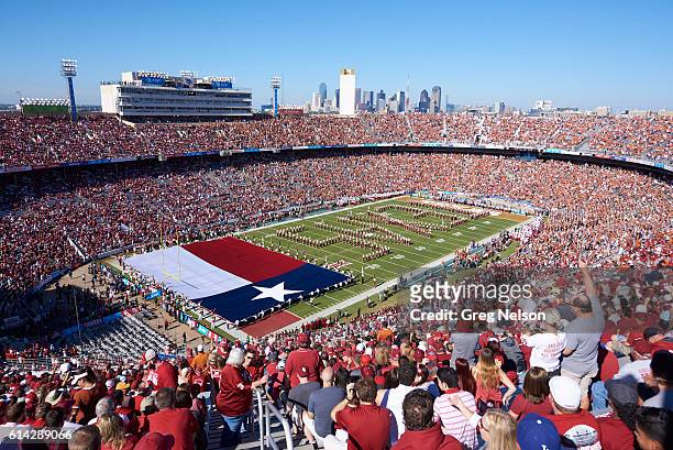 Aerial view of Texas marching band spelling out TEXAS with Texas flag being unfurled on field before game vs Oklahoma at Cotton Bowl. Dallas, TX...