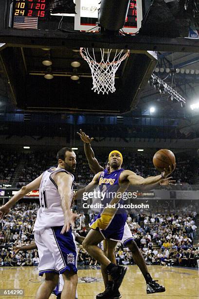 Derek Fisher of the Los Angeles Lakers goes to the basket against Vlade Divac of the Sacramento Kings in Game two of the Western Conference Finals...