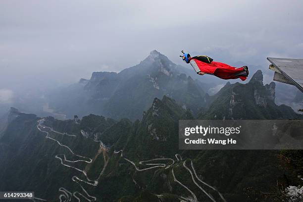 Wingsuit flyer Gabriel Lott of Brazil jumps off a mountain during the 5th World Wingsuit Championship at Tianmen Mountain on October 13, 2016 near...