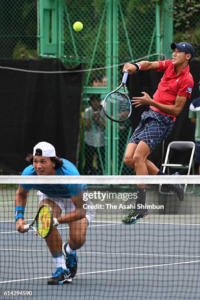 Yosuke Watanuki of Japan serves during the men's doubles first round match against Tomas Berdych and Radek Stepanek of the Czech Republic on day two...