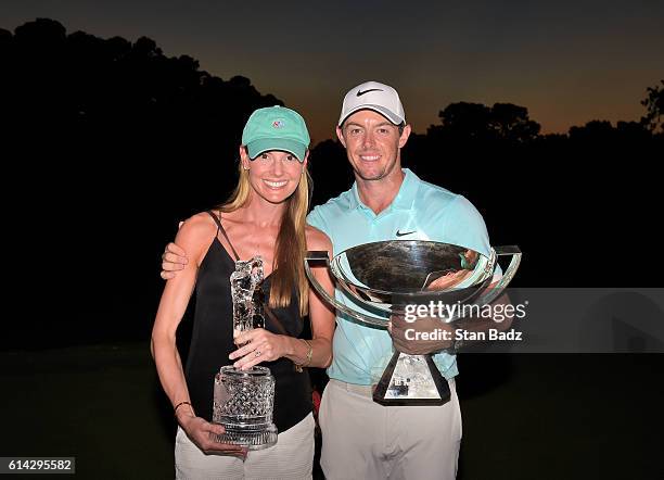 Rory McIlroy of Northern Ireland poses alongside his girlfriend Erica Stoll and the FedExCup and TOUR Championship trophies after his victory over...