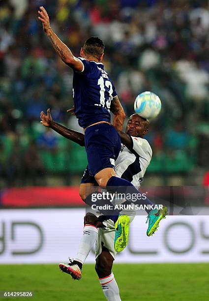 Chennaiyin FC's defender Eli Sabia Filho vies for the ball with FC Goa's forward Reinaldo Da Curz during the Indian Super League football match...