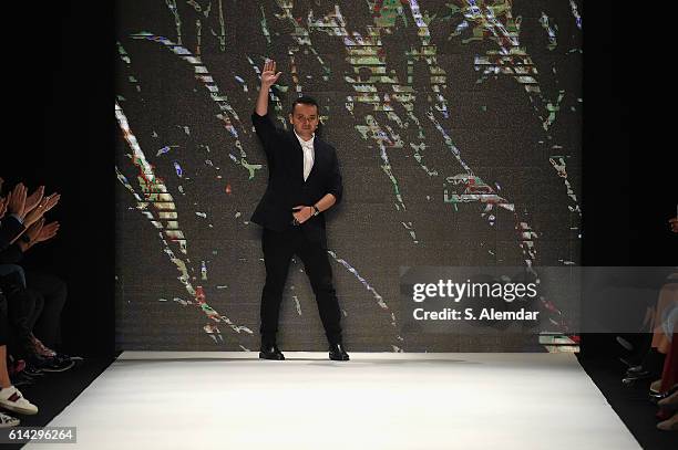 Designer Bora Aksu walks the runway at the Bora Aksu show during Mercedes-Benz Fashion Week Istanbul at Zorlu Center on October 13, 2016 in Istanbul,...