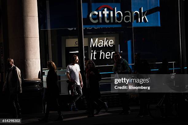 Pedestrians walk past a Citigroup Inc. Bank branch in New York, U.S., on Wednesday, Oct. 12, 2016. Citigroup Inc. Is scheduled to release earnings...