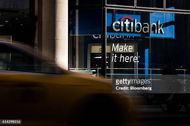 Vehicles pass in front of a Citigroup Inc. Bank branch in New York, U.S., on Wednesday, Oct. 12, 2016. Citigroup Inc. Is scheduled to release...