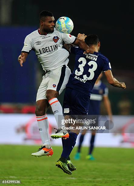 Goa's defender Rafael Dumas vies for the ball with Chennaiyin FC's defender Sanjay Balmuchu during the Indian Super League football match between...