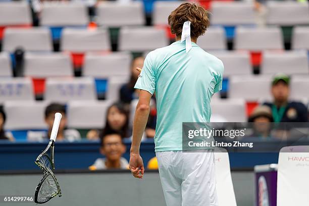 Alexander Zverev of Germany reacts by crashing his racquet the match against Jo-Wilfried Tsonga of France in the Men's singles third round match on...