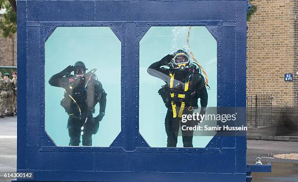 Divers salure as Queen Elizabeth II visits the corps of Royal Engineers at Brompton Barracks in celebration of their 300th anniversary on October 13,...