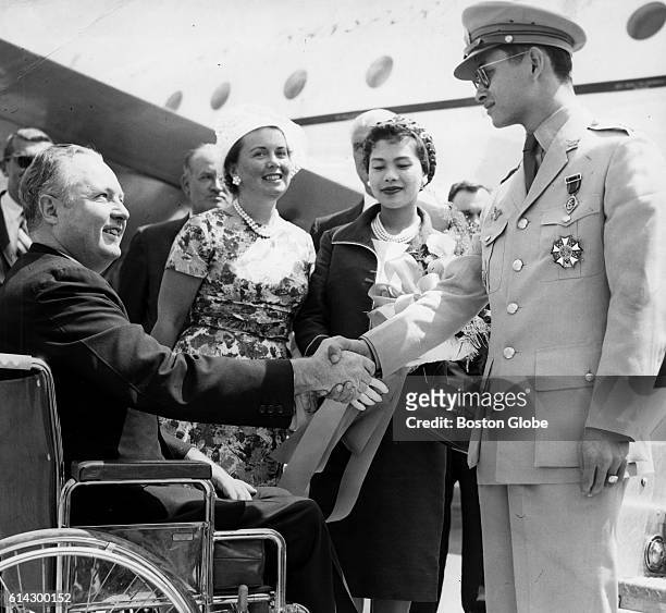 His Majesty King Bhumibol Adulyadej of Thailand shakes with Boston's Mayor John F. Collins' hand at Logan International Airport in Boston when the...