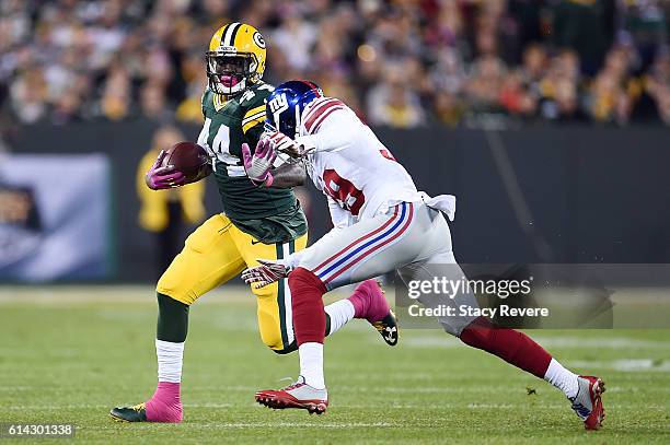 James Starks of the Green Bay Packers is pursued by Michael Hunter of the New York Giants during a game at Lambeau Field on October 9, 2016 in Green...