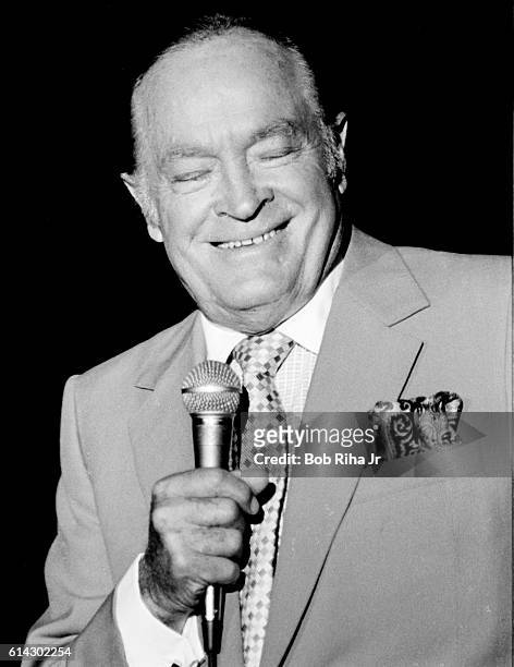 British-born American entertainer Bob Hope performs at the opening of the a joint exhibit of Howard Hughes' H-4 Hercules flying boat, popularly known...