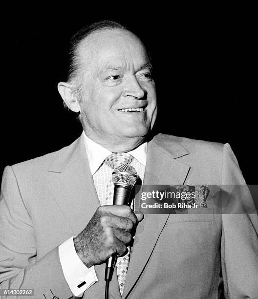 British-born American entertainer Bob Hope performs at the opening of the a joint exhibit of Howard Hughes' H-4 Hercules flying boat, popularly known...