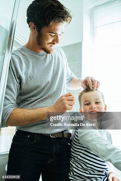 father and son getting ready in the morning - man combing hair stock pictures, royalty-free photos & images