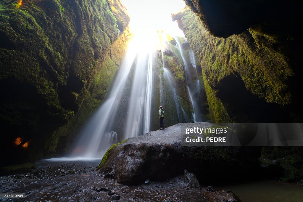 Woman admiring Gljúfrafoss waterfall