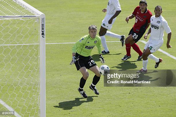 Goalkeeper Scott Garlick of the Colorado Rapids misses the save against Jason Kreis of the Dallas Burn as Robin Fraser of the Colorado Rapids and...