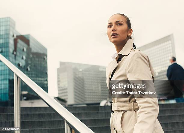 businesswoman climbing up the stairs - business woman looking over shoulder stock pictures, royalty-free photos & images