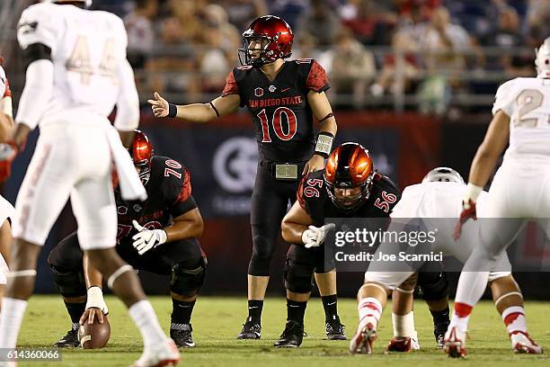 Christian Chapman of the San Diego State Aztecs makes a call from the line of scrimmage as Arthur Flores and Nico Siragusa prepare to play in the...