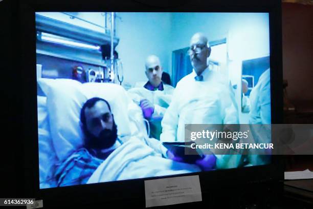 Suspected bomber Ahmad Khan Rahami attends the first court hearing on screen in Elizabeth, New Jersey while he remains in University Hospital in...