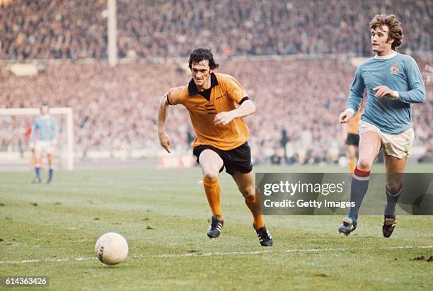 Wolves player Kenny Hibbitt and Rodney Marsh of Manchester City challenge for the ball during the 1974 League cup Final between Wolverhampton...