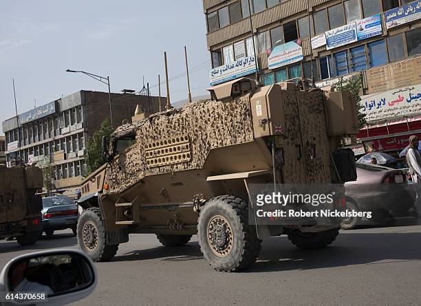 Convoy of British Army Mine Resistant Ambush Protected, or MRAPs, known as Foxhounds, works it's way through morning traffic jams in downtown Kabul...