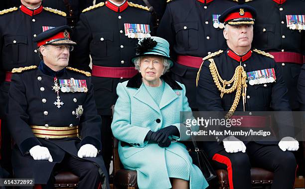 Queen Elizabeth II, Colonel-in-Chief of the Corps of Royal Engineers, poses for a photograph with soldiers of the Corps of Royal Engineers during a...