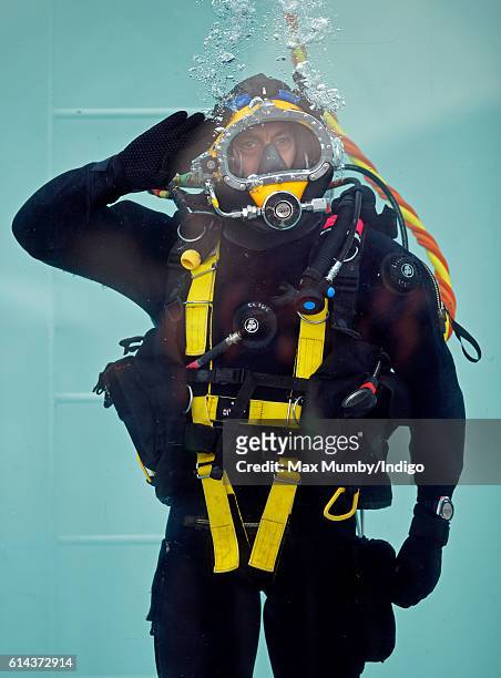 Clive Robertson, a diver of the Corps of Royal Engineers practises saluting underwater ahead of an inspection by Queen Elizabeth II as she visits...