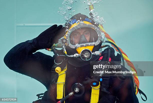 Clive Robertson, a diver of the Corps of Royal Engineers practises saluting underwater ahead of an inspection by Queen Elizabeth II as she visits...