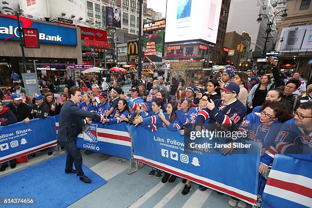 Dylan McIlrath of the New York Rangers greets fans as he walks down the Blue Carpet prior to the game against the New York Islanders at Madison...