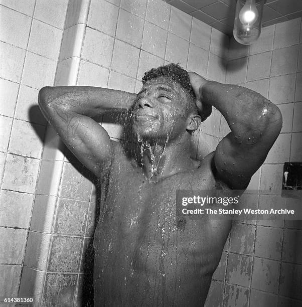 Floyd Patterson takes a shower after training at the Gramercy Gym on 14th Street, New York, New York, on January 01, 1954.