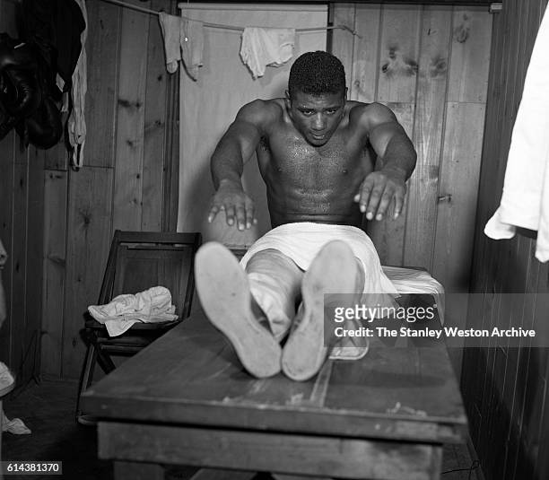 Floyd Patterson in a middle of a set of crunches at his training camp on May 12, 1956 at Greenwood Lake, New York.
