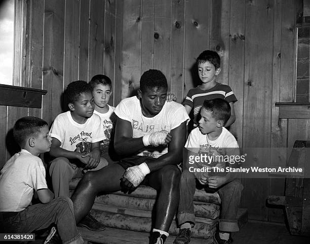 Floyd Patterson takes some time out of training to talk to some young boys at his training camp on May 12, 1956 at Greenwood Lake, New York.