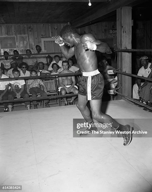 Floyd Patterson exhibits his pugilistic skills to a packed crowd at his training camp on May 12, 1956 at Greenwood Lake, New York.